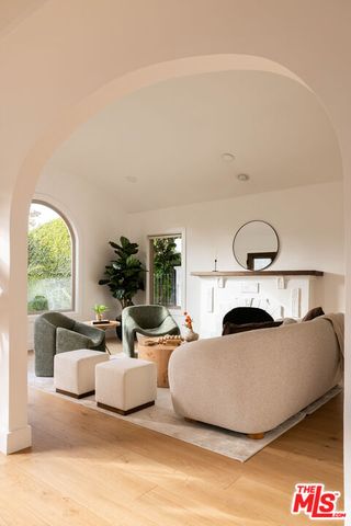 a living room with furniture a window and a fireplace
