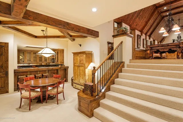a dining room with furniture and a chandelier