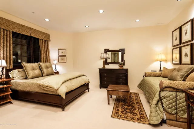 a spacious bedroom with a bed a couch and a window