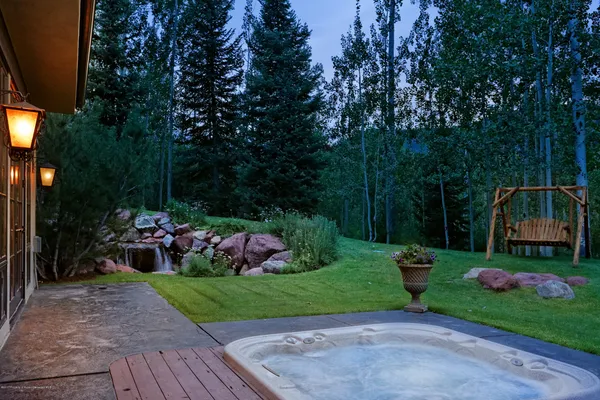 a view of a garden with flowers and trees