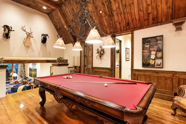 a room with furniture pool table and windows