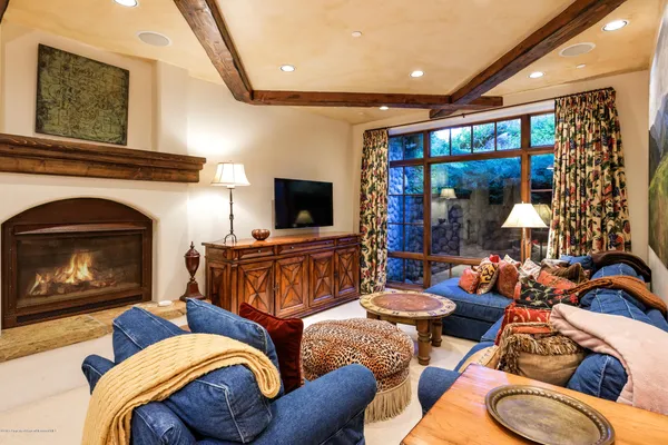 a living room with furniture a fireplace and a flat screen tv