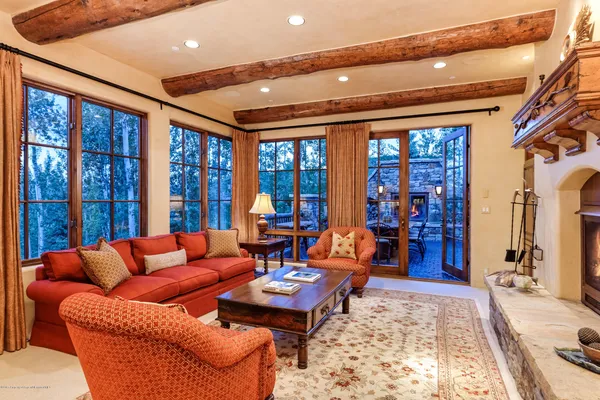 a living room with furniture a rug and a large window
