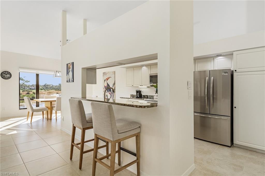 a kitchen with stainless steel appliances a refrigerator and a dining table