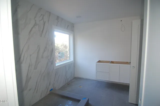 a utility room with cabinets washer and dryer