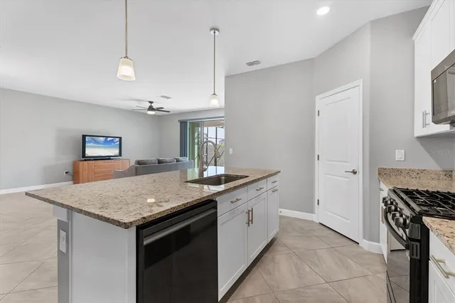 a living room with granite countertop furniture and chandelier