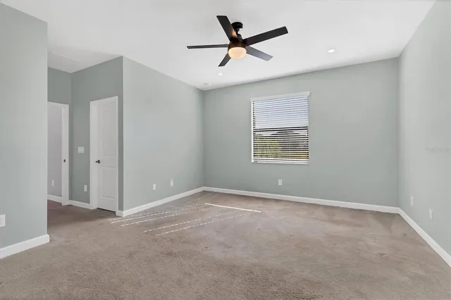 an empty room with a kitchen and a window