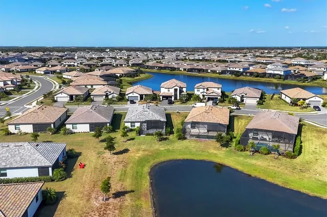 a living room with furniture a flat screen tv and a large window