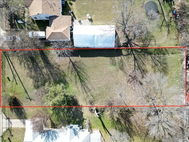 an aerial view of a houses with a yard