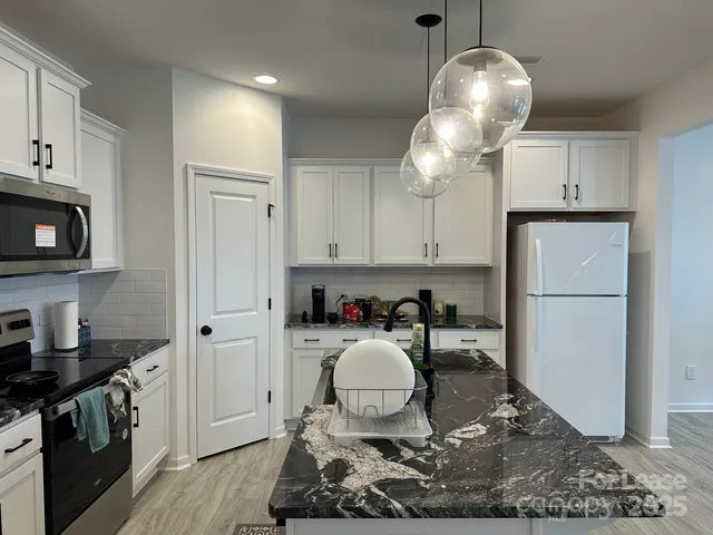 a kitchen with a sink cabinets and stainless steel appliances