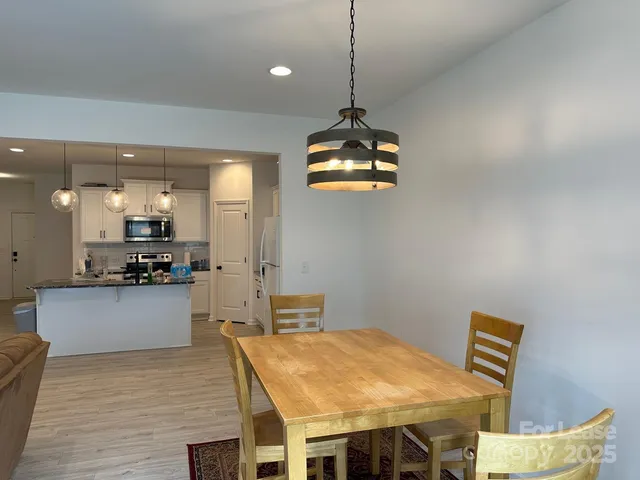 a kitchen with a table and chairs in it