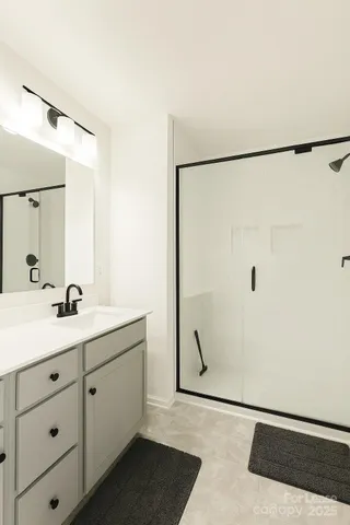 a bathroom with a double vanity sink a mirror and shower