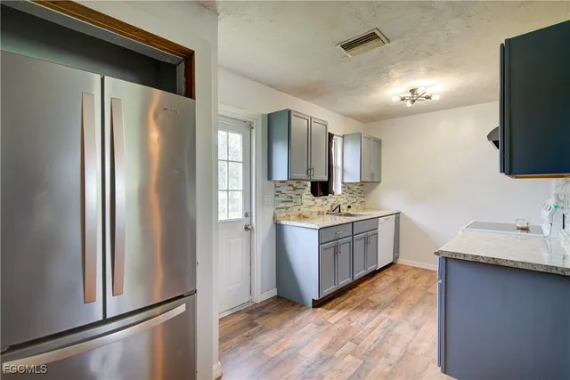 a kitchen with a refrigerator sink and microwave