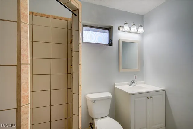 a bathroom with a toilet sink and mirror