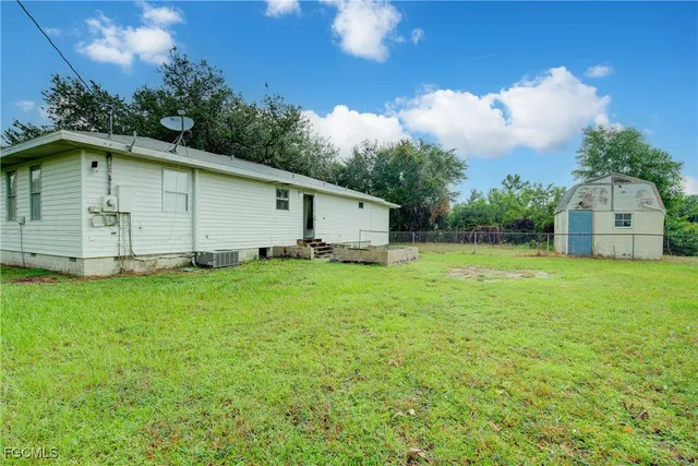 a white house that has a tree in front of it