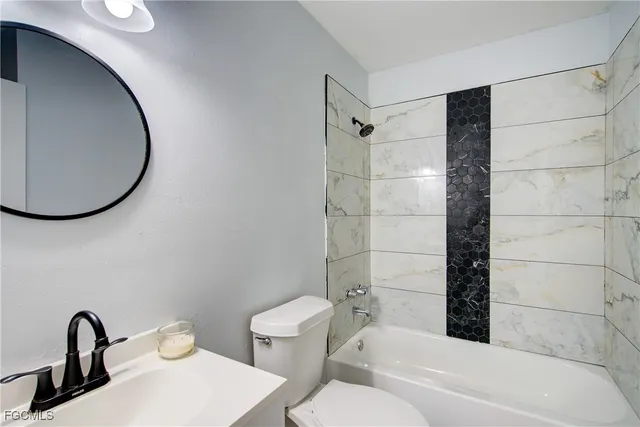 a bathroom with a toilet and a tub