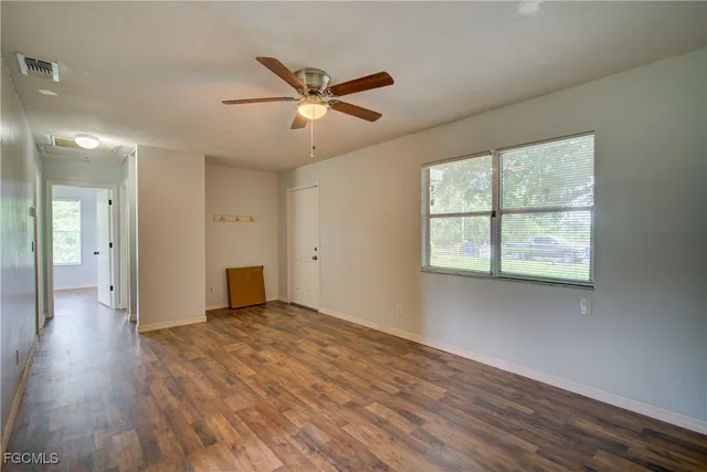 wooden floor in an empty room with a window