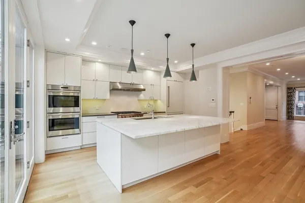 a large kitchen with stainless steel appliances