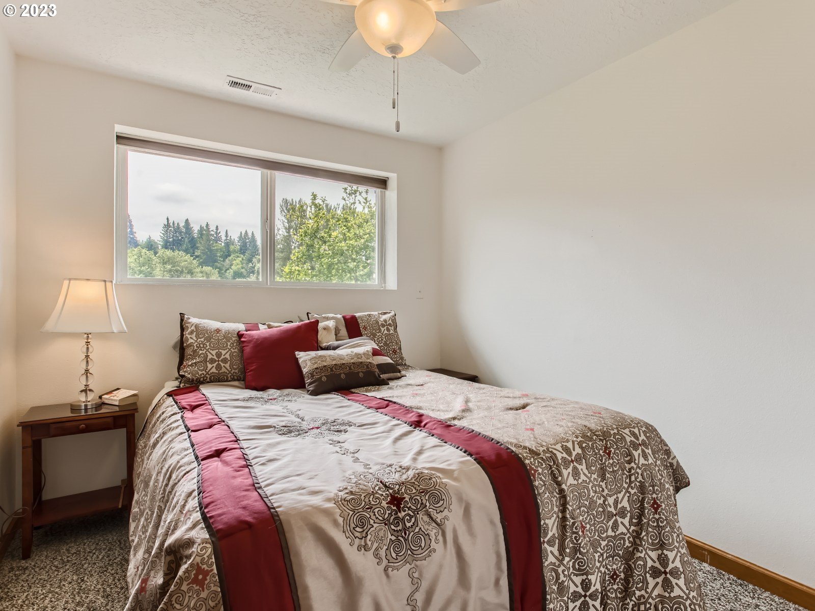 29243 Southeast Stone Road Gresham, OR 97080 - Photo 23 of 35 a bed sitting in a bedroom next to a window