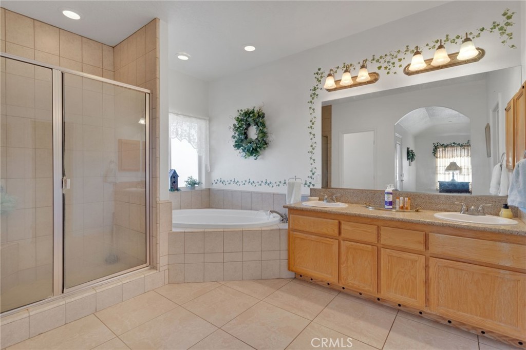 8482 Tumbleweed Road Phelan, CA 92371 - Photo 23 of 61 a spacious bathroom with a tub sink and mirror