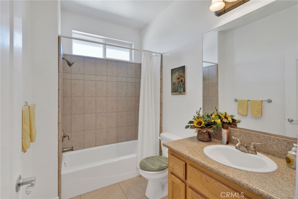 8482 Tumbleweed Road Phelan, CA 92371 - Photo 31 of 61 a bathroom with a granite countertop sink toilet and shower