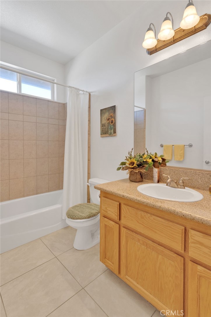 8482 Tumbleweed Road Phelan, CA 92371 - Photo 32 of 61 a bathroom with a double vanity sink toilet and shower