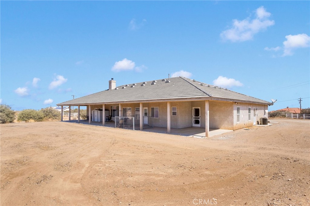 8482 Tumbleweed Road Phelan, CA 92371 - Photo 40 of 61 a front view of a house with a yard and trees