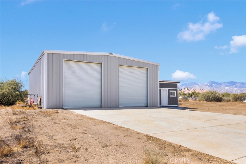 8482 Tumbleweed Road Phelan, CA 92371 - Photo 43 of 61 a view of a house with a snow in the yard