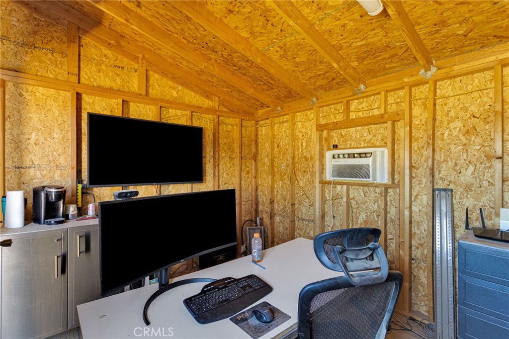 8482 Tumbleweed Road Phelan, CA 92371 - Photo 46 of 61 a living room with furniture and a flat screen tv