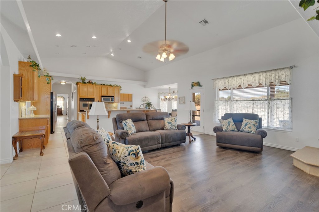 8482 Tumbleweed Road Phelan, CA 92371 - Photo 8 of 61 a living room with furniture chandelier and a large window