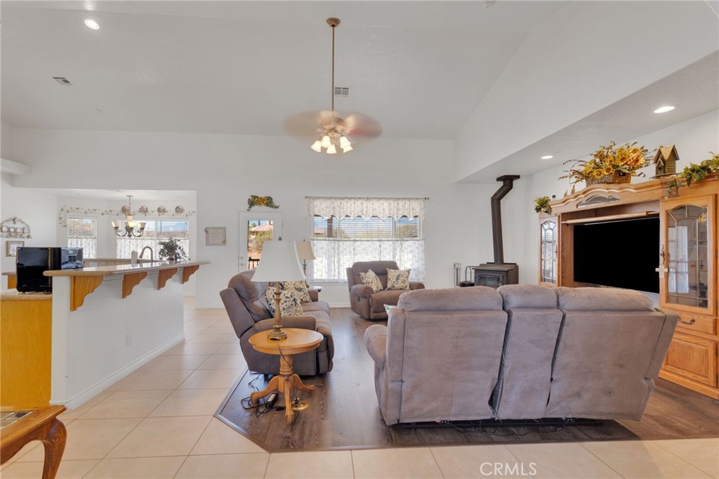 8482 Tumbleweed Road Phelan, CA 92371 - Photo 10 of 61 a living room with fireplace furniture and a chandelier