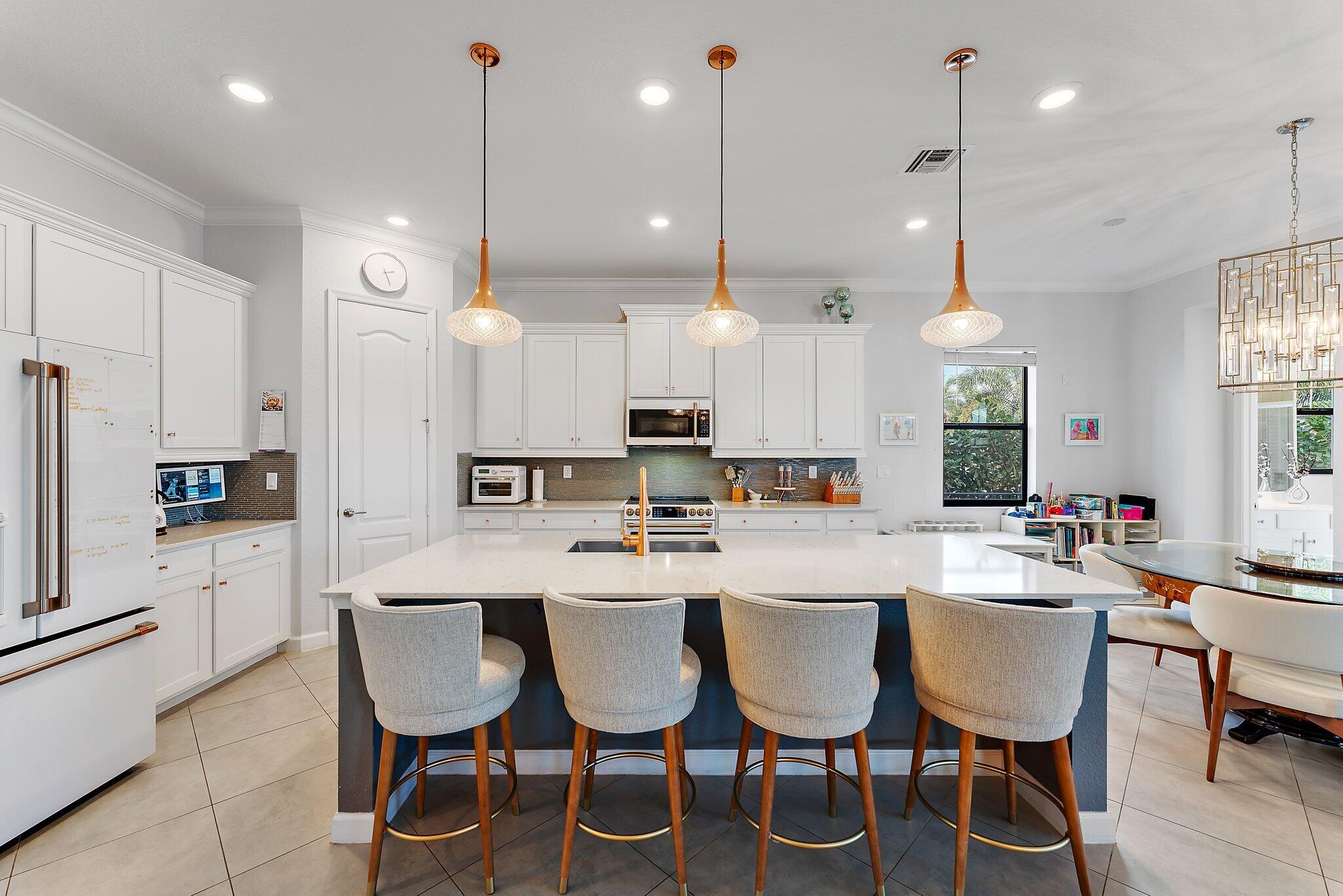 3134 Streng Lane Royal Palm Beach, FL 33411 - Photo 1 of 44 a large kitchen with a table and chairs