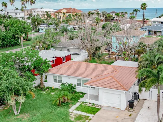 a aerial view of a house with yard and green space