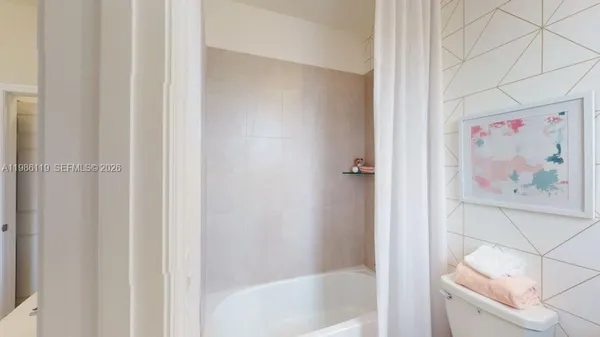 a bath room with a shower and a bath tub