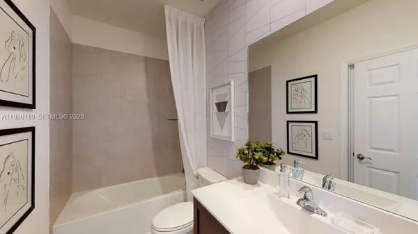 a bath room with a toilet a sink and a bathtub