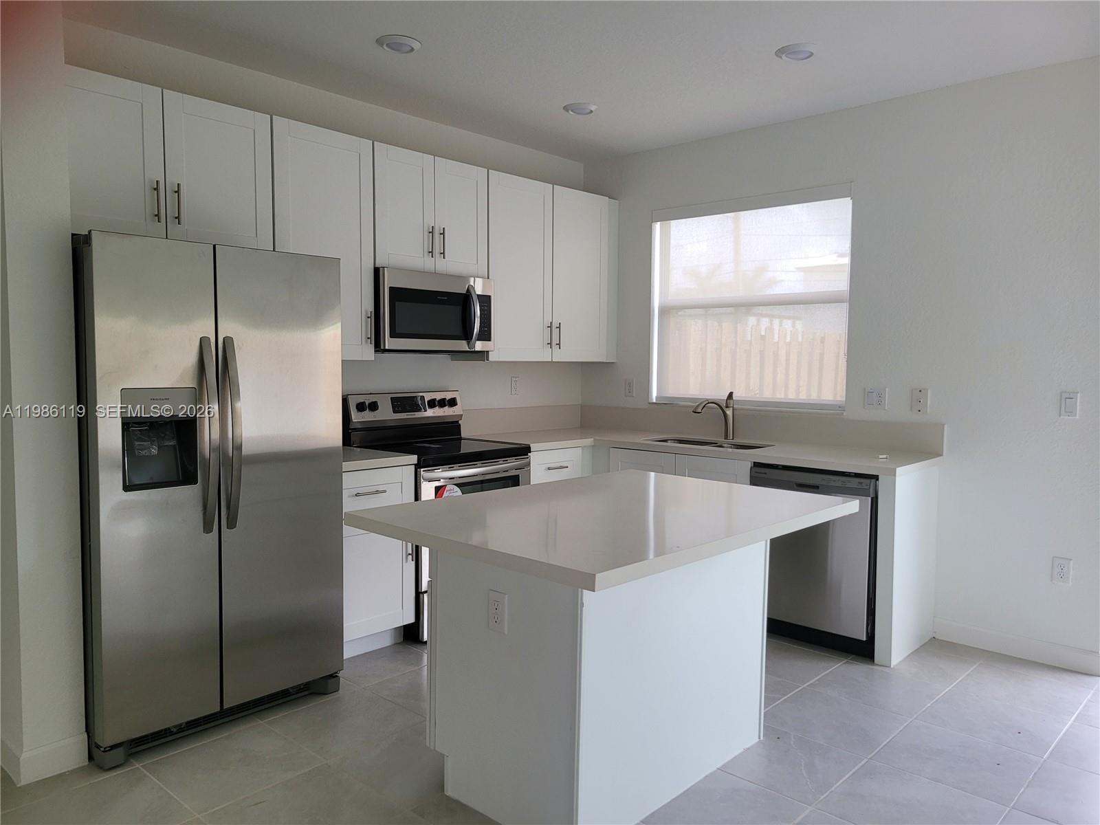 28667 Southwest 132nd Court Homestead, FL 33033 - Photo 15 of 20 a kitchen with stainless steel appliances a refrigerator sink and microwave