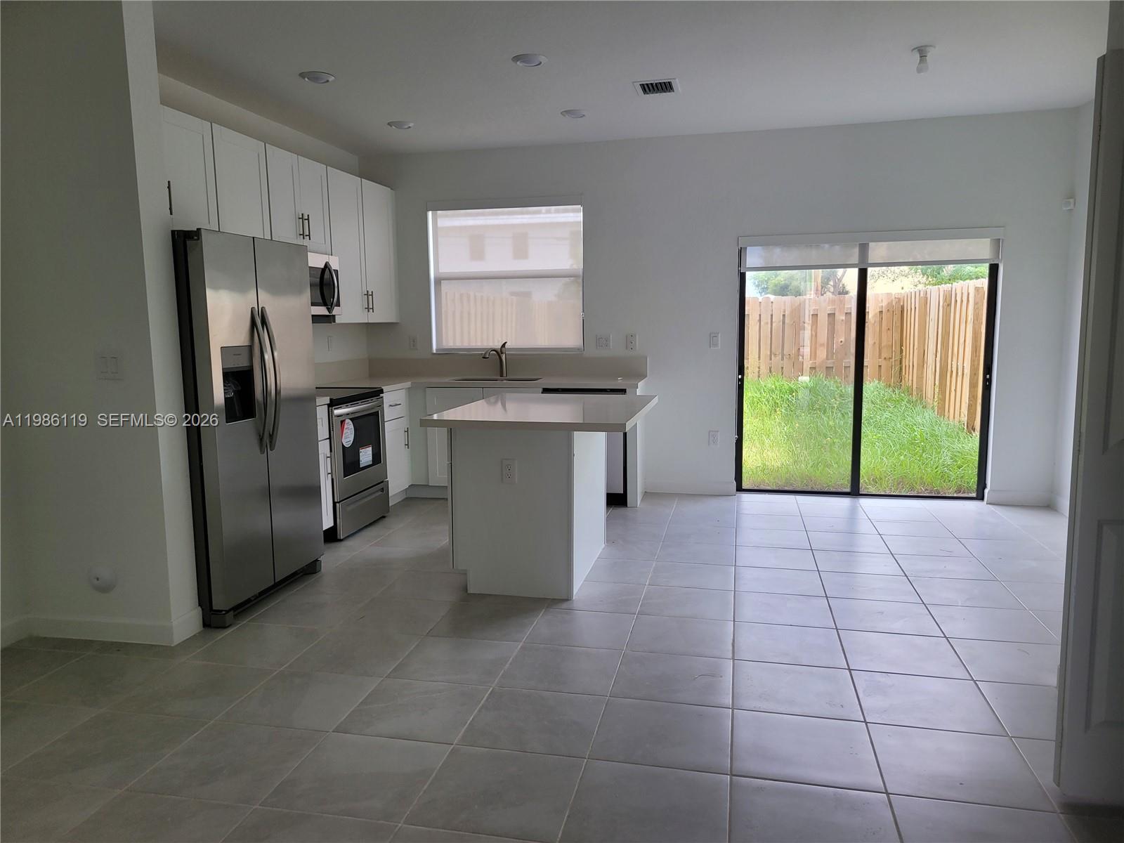 28667 Southwest 132nd Court Homestead, FL 33033 - Photo 18 of 20 a kitchen with stainless steel appliances a refrigerator sink and stove