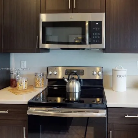 a stove top oven sitting inside of a kitchen