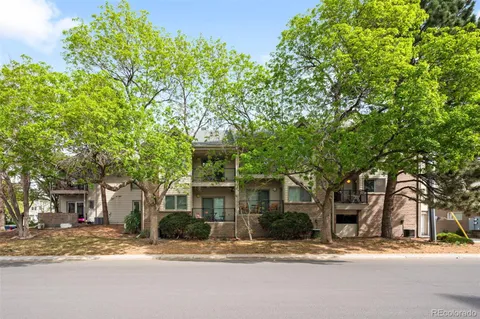 a front view of a house with a tree