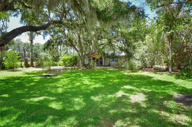 a backyard of a house with lots of green space