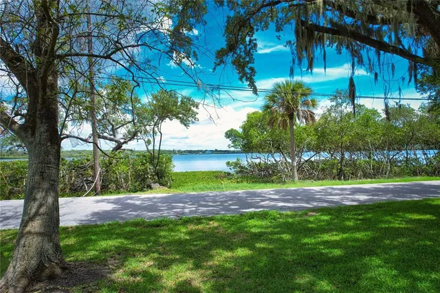 a view of a small house with a yard