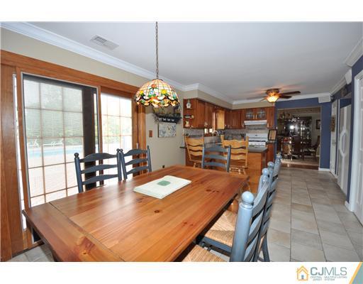 36 Higgins Road Old Bridge, NJ 08857 - Photo 3 of 12 a dining room filled with lots of furniture and chandelier
