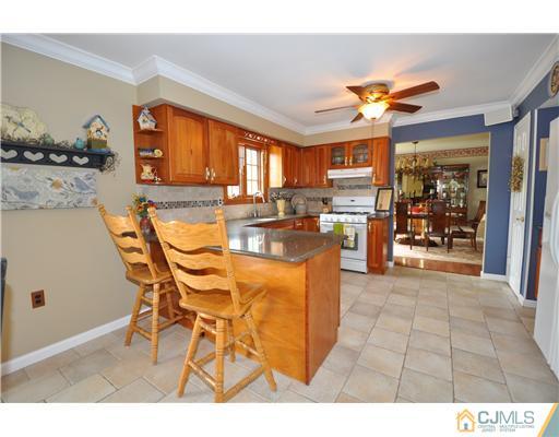 36 Higgins Road Old Bridge, NJ 08857 - Photo 4 of 12 a very nice looking dining room with kitchen island furniture a large window and a fireplace