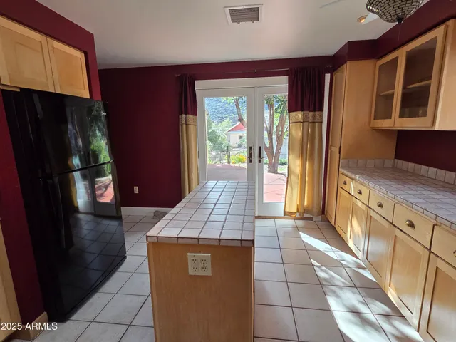 a hallway with sliding door and wooden cabinets