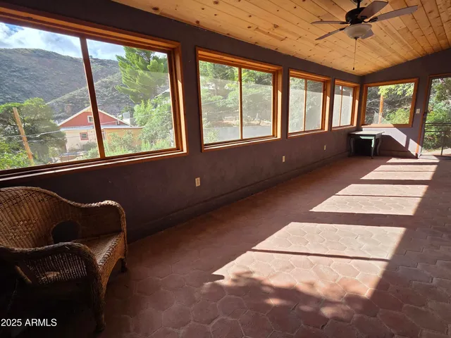 a view of a balcony with wooden floor and door