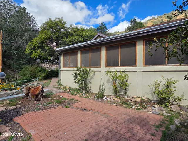 a backyard of a house with table and chairs