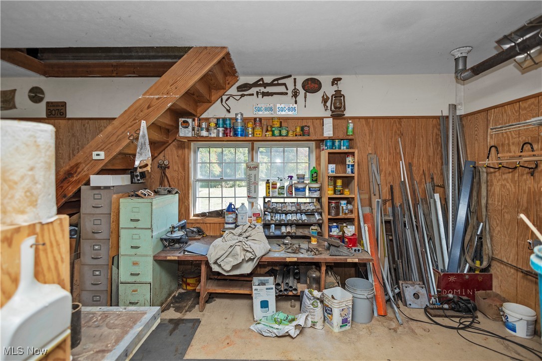 3158 Narrows Road Perry, OH 44081 - Photo 16 of 43 Misc room with concrete flooring, wood walls, and a workshop area