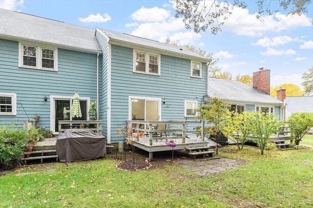 a balcony with wooden floor and outdoor seating