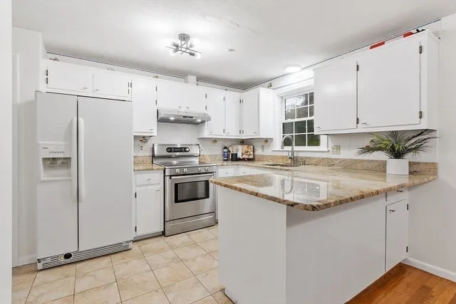 a kitchen with stainless steel appliances granite countertop a refrigerator sink and cabinets