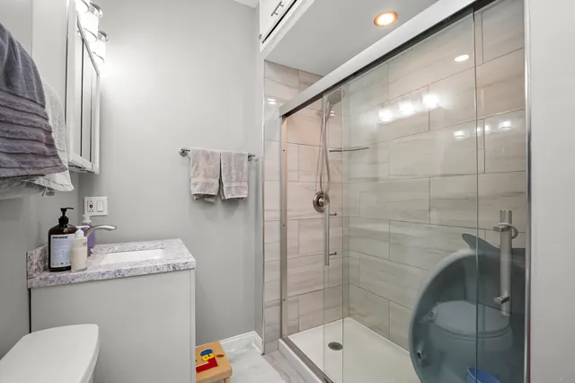 a bathroom with a sink toilet and shower